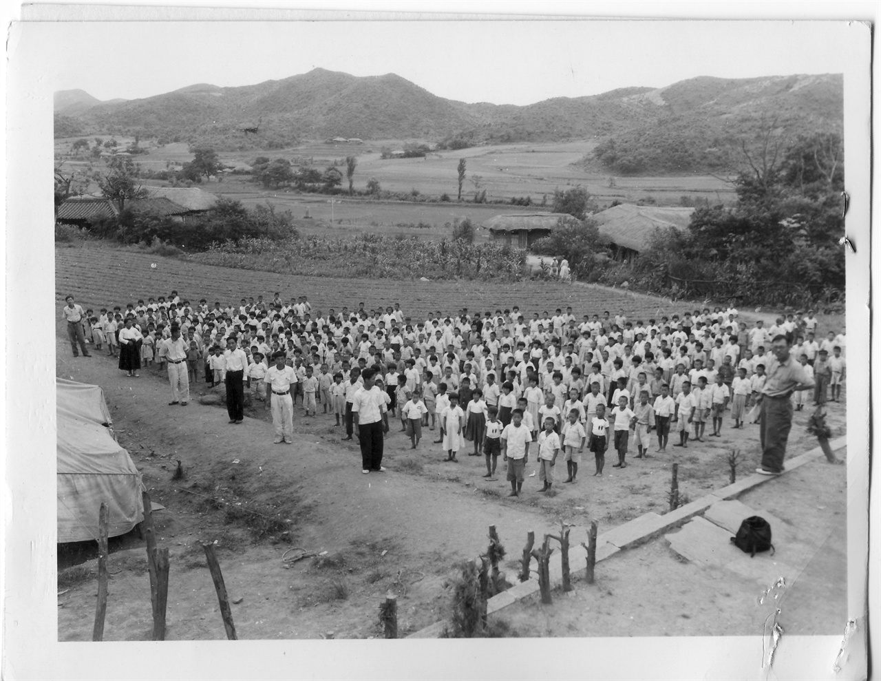  1952. 7. 동구 밖 밭에다가 임시로 천막을 친 초등학교의 애국 조회시간. 