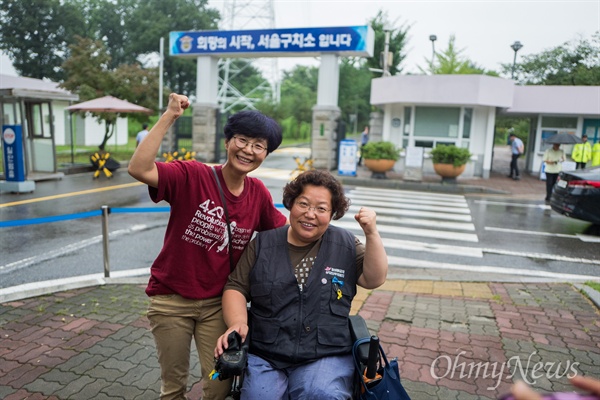 장애인 활동가 박옥순, 이형숙씨가 24일 오후 경기도 의왕시 서울구치소 앞에서 출소 직후 파이팅을 외치고 있다. 