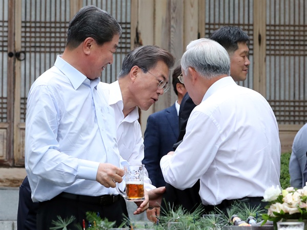 문재인 대통령이 27일 오후 청와대 상춘재에서 열린 주요 기업인과의 호프미팅에서 손경식 CJ 회장의 겉옷을 받아주고 있다.