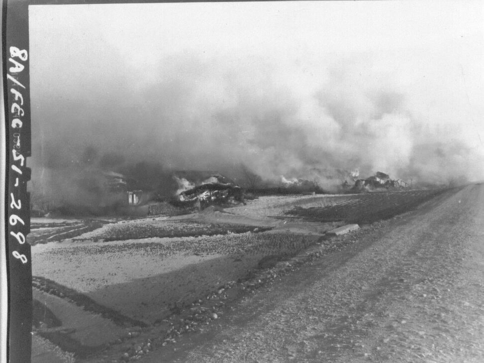  전투기 폭격으로 불타고 있는 마을.