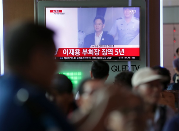 25일 오후 서울역에서 시민들이 이재용 삼성전자 부회장의 재판 관련 뉴스를 지켜보고 있다.