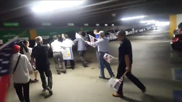 지난 27일(현지시각) 북 콘서를 위해 미국 LA를 방문한 안민석 의원이 보수 단체의 기습 시위에 지하 주차장에서 차에 갇히는 일이 일어났다. 사진은 안 의원 일행을 쫓아가는 보수단체 회원들(동영상 캡처)