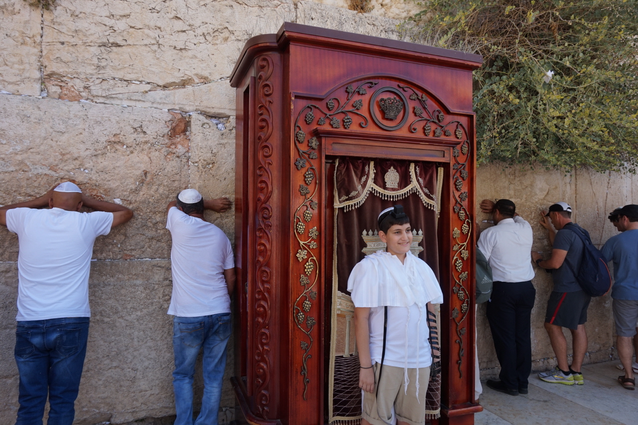 통곡의 벽에서 기도하는 사람들과 성년식을 맞이한 유대인 소년