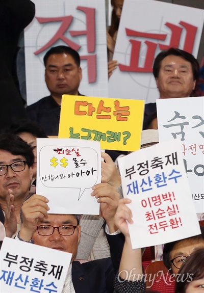 25일 오후 서울 여의도 국회 의원회관에서 열린 국민재산되찾기 운동본부 출범식 및 창립총회에서 참석자들이 피켓을 들고 있다.