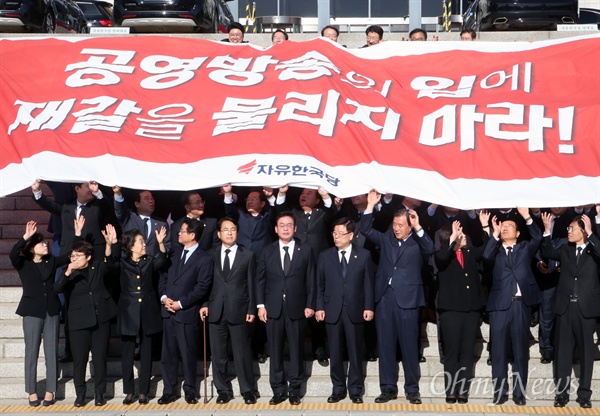 국정감사 보이콧을 철회하고 국감 복귀를 결정한 자유한국당 의원들이 30일 오전 국회 본관 계단에서 '공영방송의 입에 재갈을 물리지 마라!'라고 적힌 대형 현수막을 펼치고 있다. 
