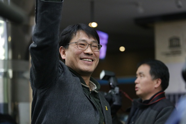  KBS 새노조 성재호 위원장이 고대영 사장 해임 가결 소식을 듣고 기뻐하며 주먹을 쥐고 오른손을 높게 뻗고 있다. 