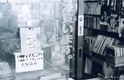 일본 도쿄 책집거리. '100엔 책'을 판다고 알리는 종이가 유리문에 붙었다.