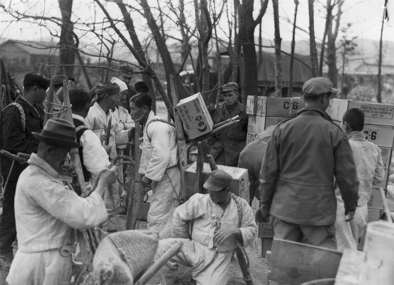 1951. 2. 4. 한국의 노무자들이 군수물자를 지게로 져서 나르고 있다.