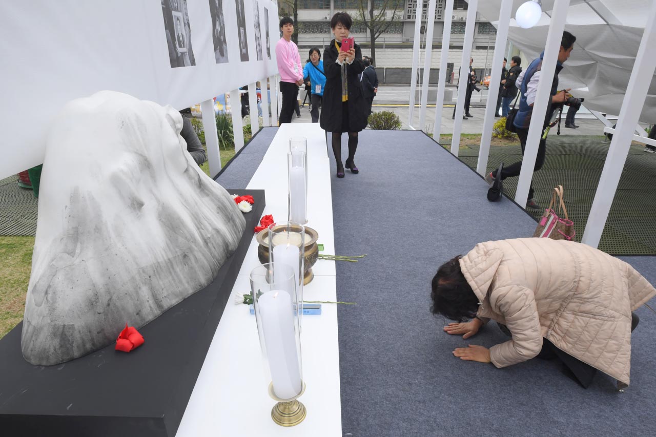 제주 4.3 70주년 광화문 추념식이 3일 오전 서울시 종로구 광화문광장에서 열리고 있는 가운데 한 추모객이 행사장 한켠에 마련된 추모공간을 찾아 절을 하고 있다. 2018.04.03