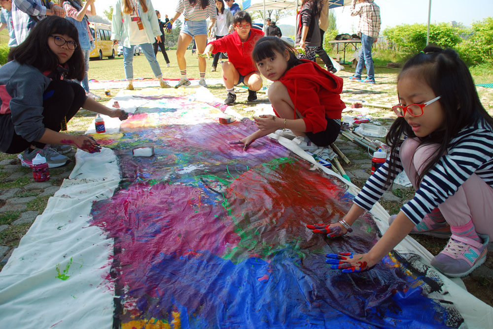강혁 작가와 미대 학생들이 밑그림을 그린 대형 물고기에 참석한 학생들이 색을 칠하고 있다.