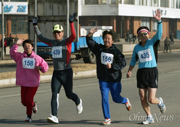 오마이뉴스 주최 '평양-남포 통일 마라톤대회`가 2005년 11월 24일 오전 평양 서산경기장에서 남북 선수 200여명이 참석한 가운데 성황리에 열렸다. 남북의 선수들이 평양시내를 달리며 손을 흔들고 있다.  