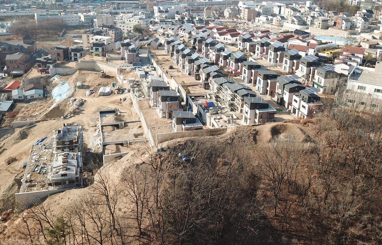 산 정상의 숲이 모두 사라지고 집이 들어섰다. 이제 난개발을 멈추고 숲을 보존하자. 