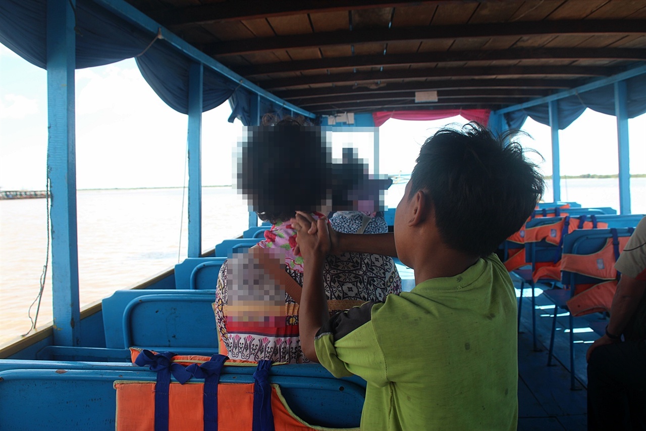 톤레샵 호수 목선에서 관광객들에게 목마사지와 안마서비스를 하는 아이들 모습
