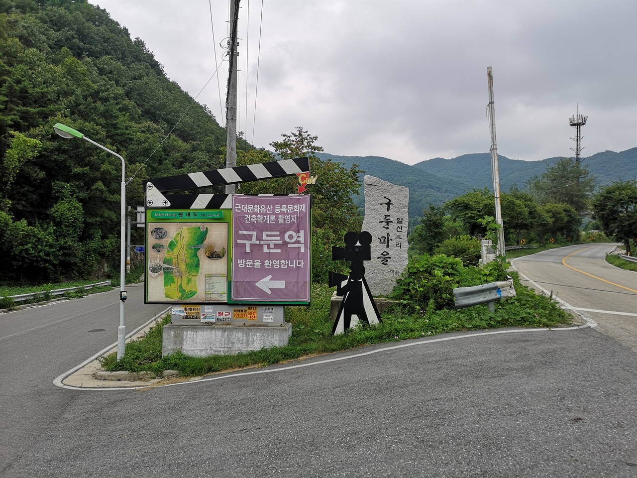 구둔역으로 가는 산길을 알려주는 이정표. '국민여동생'으로 불렸던 수지의 <건축학개론>의 촬영지임을 강조하는 영화 촬영 카메라의 모형이 서있어 이곳이 영화 촬영지임을 알 수 있게 하였다.