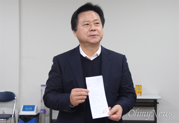 자유한국당 강기윤 예비후보가 12월 4일 창원성산선거관리위원회에 예비후보 등록한 뒤 접수증을 들어 보이고 있다.