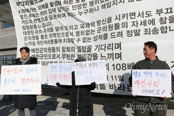 예천군민들이 1일 오전 예천군의회가 열리기 전 의회 앞에서 물의를 빚은 군의원 전원 사퇴를 촉구하는 피켓을 들고 서 있다.