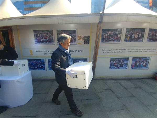 17일 오전 서울광화문광장에서 세월호 희생자들의 영정을 옮기는 '이운식'이 진행됐다. 유족들과 시민 100여 명이 참석했다. 박래군 공동대표가 희생자들의 영정사진을 옮기고 있다.