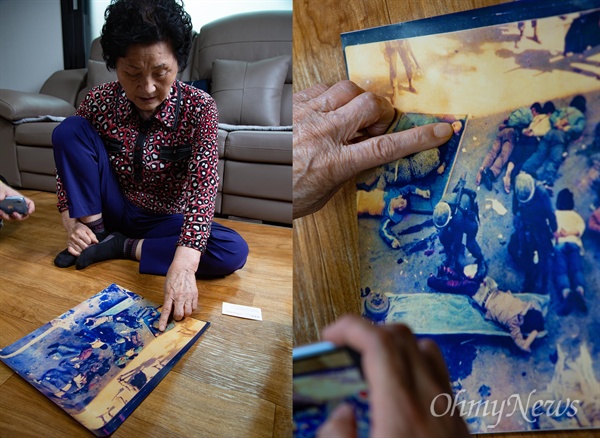 1980년 5월 27일 계엄군에 의해 전남도청에서 사망한 '고등학생 시민군' 고 문재학(당시 16세, 광주상고 1)씨 어머니 김길자(80)씨가 시신들 사진 속에서 아들의 모습을 손가락으로 가리키고 있다.