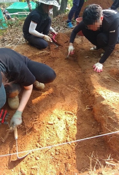 한국전쟁기민간인학살유해발굴공동조사단이 아산시 염치읍 백암리 민간인 희생자 유해발굴 현장에서 유해발굴을 하고 있다.