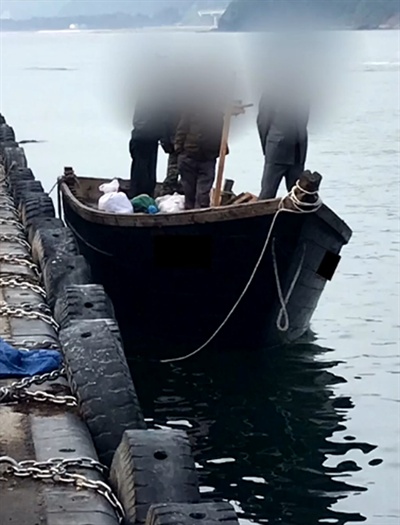 지난 15일 북한 선원 4명이 탄 어선이 삼척항 내에 정박한 뒤 우리 주민과 대화하는 모습. 2019.6.18 [KBS 제공]