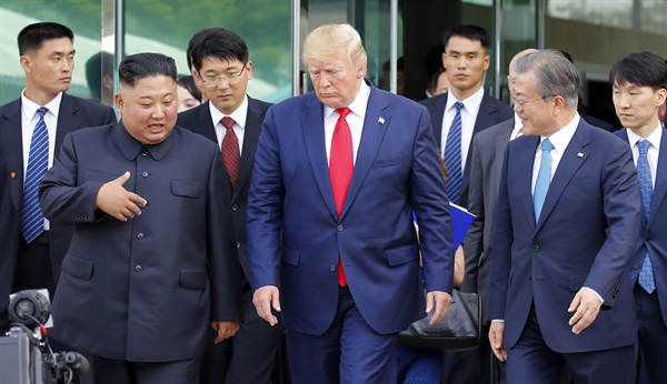 도널드 트럼프 미국 대통령, 김정은 북한 국무위원장이 30일 오후 판문점 남측 자유의 집에서 회동을 마친 뒤 문재인 대통령과 함께 군사분계선으로 이동하고 있다.

