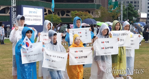 경기도 고양시 양일중학교 영어동아리 학생들이 15일 서울광장에서 열린 '광복 74주년 일제 강제동원 문제해결을 위한 시민대회'에 참석해 일본 정부를 규탄하는 현수막을 펼쳐 들고 있다.