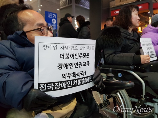 장애인 단체 회원들이 23일 용산역에서 이해찬 더불어민주당 대표의 장애인 비하 발언에 항의하며 사과를 촉구하고 있다.