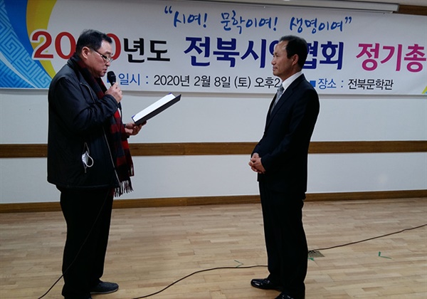 전북시인협회 제8대 회장으로 당선된 김현조 신임 회장이 박철영 전북시인협회 선거관리위원장으로부터 당선증을 받고 있다. 