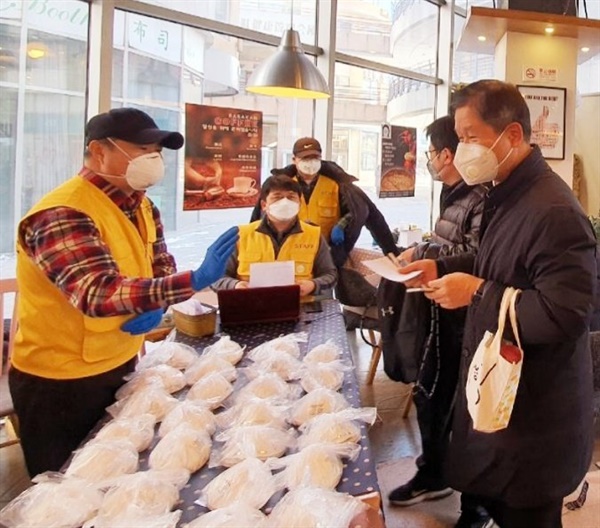 한국에서 보내온 마스크를 북경 한인회 봉사요원들이 한국인들에게 나눠주고 있다.