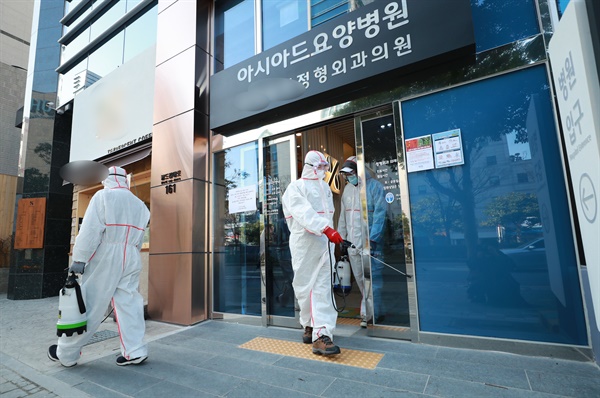  24일 오후 부산 연제구 아시아드요양병원과 같은 건물을 쓰는 1층 한 병원에서 병원 관계자가 방역하고 있다. 코로나19 확진 환자가 나온 부산 아시아드 요양병원이 코호트 격리됐다. 