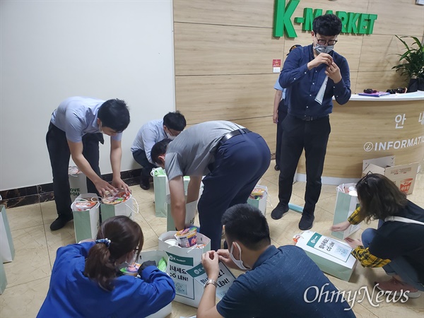 K-Market 직원들이 하노이에 격리된 한국인에게 전달할 물품을 쇼핑백에 담고 있다.