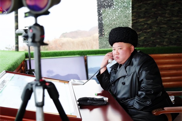 북한 군 합동타격훈련을 참관한 김정은 북한 국무위원장이 실내 감시소에서 누군가와 통화하는 모습을 조선중앙TV가 지난 2월 29일 보도했다. 김 위원장은 마스크를 쓰지 않은 모습이며, 책상에도 담배와 장갑만 보인다. 