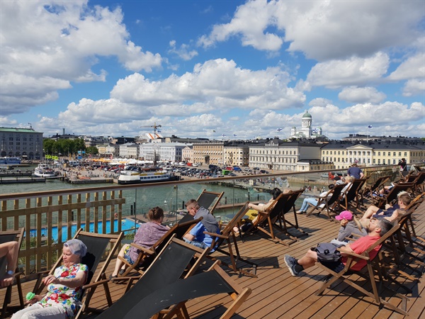  Finland is a country of mountains, lakes, and seas. Citizens enjoying sunbathing at the port of Helsinki last summer.