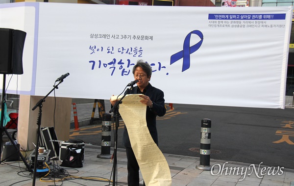 김유철 시인이 4월 29일 저녁 창원 용호동 문화거리에서 열린 '삼성중공업 크레인사고 3주기 추모문화제'에서 추모시를 낭송하고 있다.