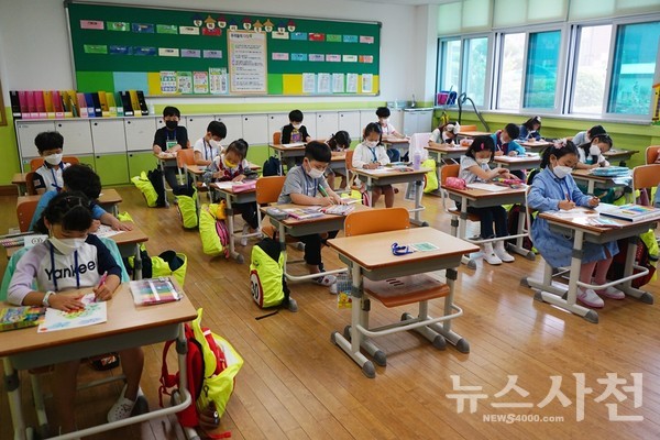 시험대형으로 최대한 거리를 띄운 채 앉아 수업을 듣고 있는 초등학생들.
