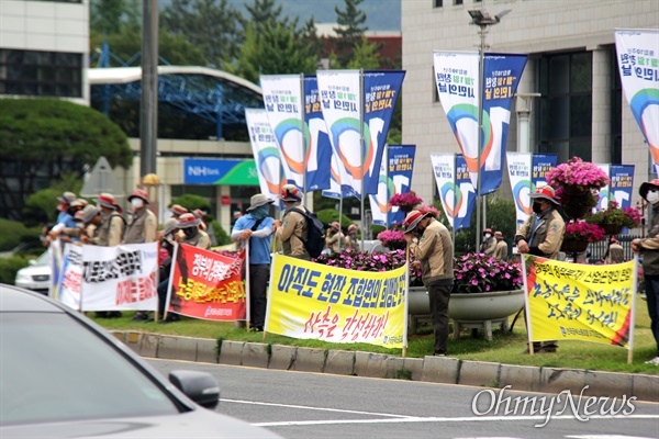 전국금속노동조합 STX조선지회 조합원들은 6월 17일 창원시청 앞 광장에서 갖가지 구호를 새진 펼침막을 들고 서 있다.
