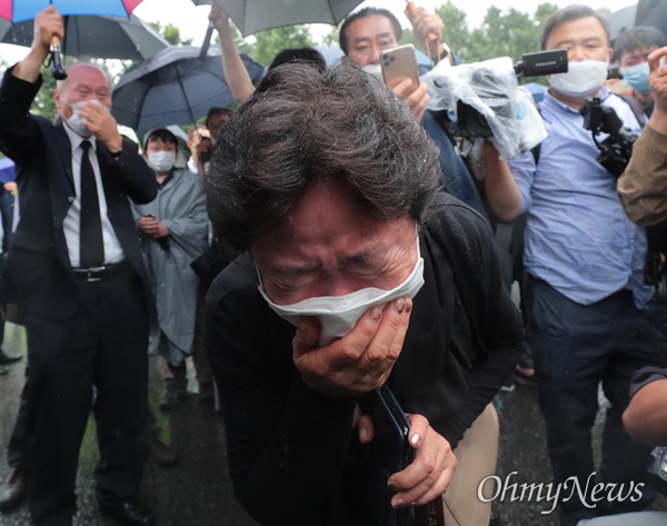  :13일 오전 박원순 서울시장의 온라인 영결식이 끝난 뒤 위패와 영정사진이 서울시청사를 빠져나와 추모공원으로 향하자 서울광장을 찾은 시민들이 슬퍼하고 있다.