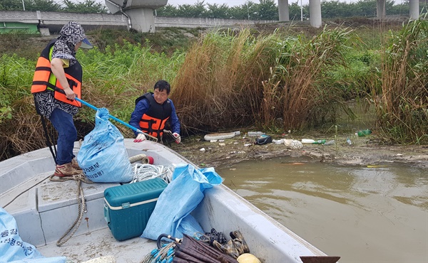 폭우로 낙동강하구에 쓰레기 더미가 쌓이자 15일 (사)생명그물, 낙동강하구기수생태계복원협의회, 한국어촌사랑협회가 어선 4척을 동원해 환경보호 활동에 나섰다.