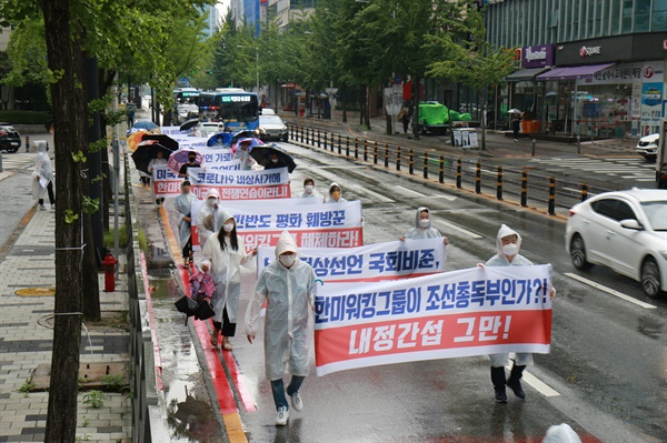  참가자들이 현수막을 들고 행진하고 있다.