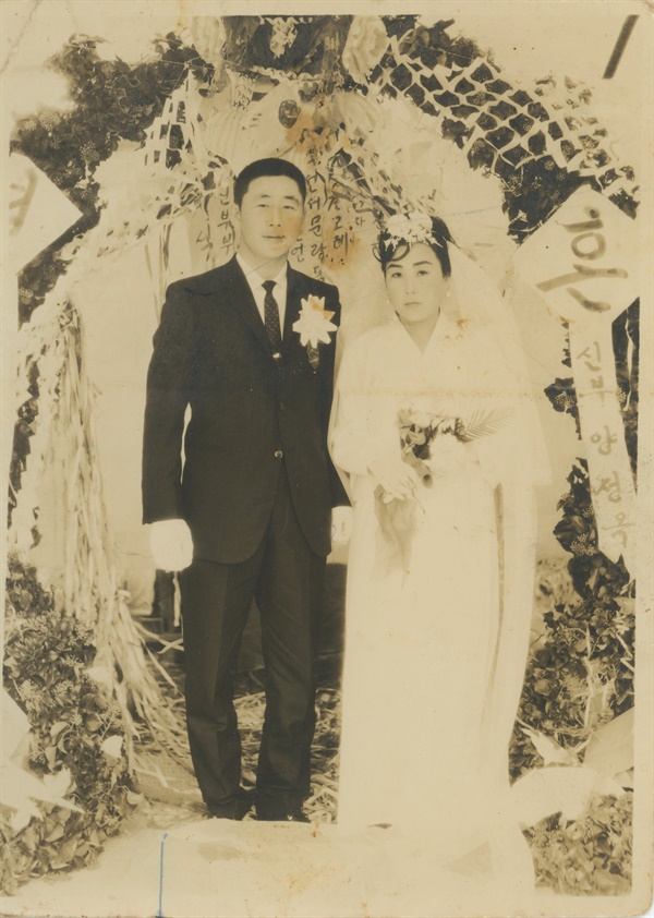김평강과 아내 양정옥의 결혼 사진. 친구들이 손수 만들어 준 꽃터널 앞에서 기념사진을 찍었다.