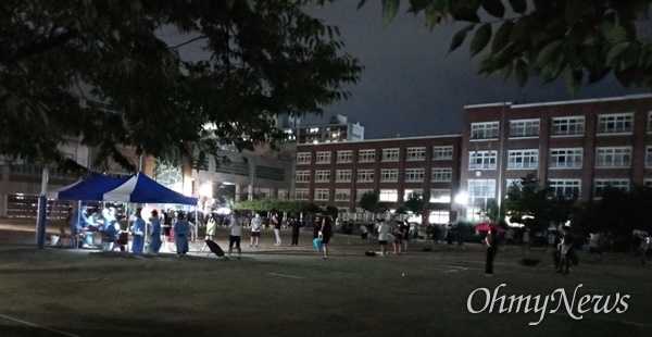 23일 밤, 비가 내리는 속에서도 운동장 천막 선별진료소에 모여든 대구 A중학교 학생과 교직원들. 