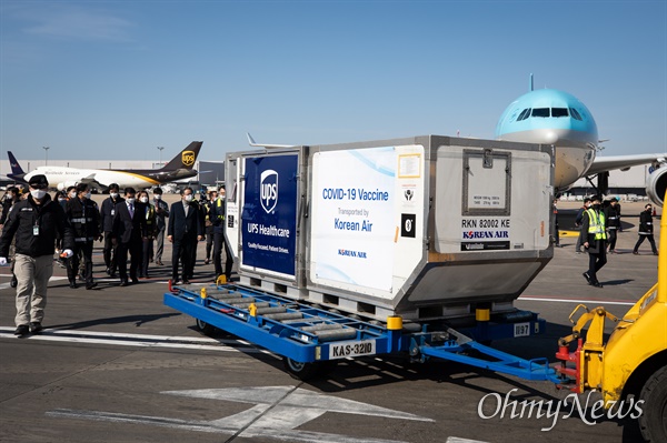  화이자가 개발한 코로나19 백신이 26일 인천국제공항 회물터미널에 도착해 관계자들이 백신을 옮기고 있다. 극저온 상태로 암스테르담에서 인천공항까지 대한항공 화물기를 통해 도착한 백신은 이후 군 수송지원본부 호위 하에 서울국립중앙의료원 등 5개 도시의 접종센터로 안전하게 배송된다.