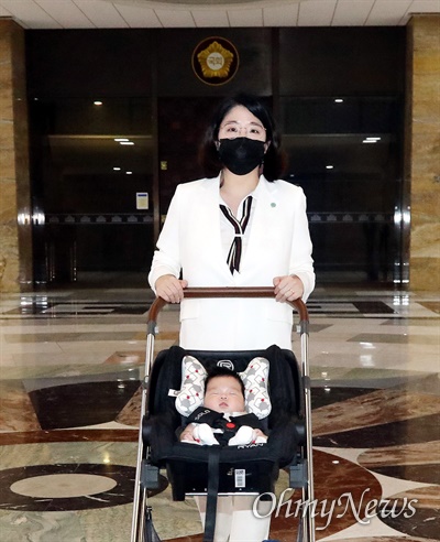 기본소득당 용혜인 의원이 생후 59일 아들과 함께 5일 서울 여의도 국회에 '출산 후 첫 등원'을 해 로텐더홀을 지나고 있다. 