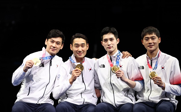구본길, 김정환, 김준호, 오상욱이 28일 일본 지바의 마쿠하리 메세에서 열린 도쿄올림픽 남자 펜싱 사브르 단체전 시상식에서 금메달을 보여주며 있다.