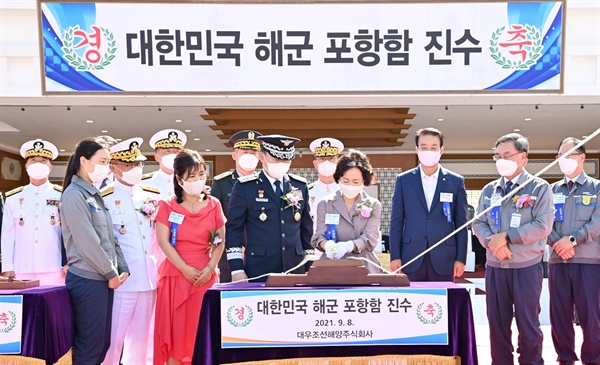  8일 오후 경남 거제시 대우조선해양 옥포조선소에서 열린 해군의 신형 호위함 포항함 진수식에서 원인철 합참의장 부인 이혜명 여사가 해군 관습에 따라 손도끼로 함정에 연결된 진수줄을 절단하고 있다.