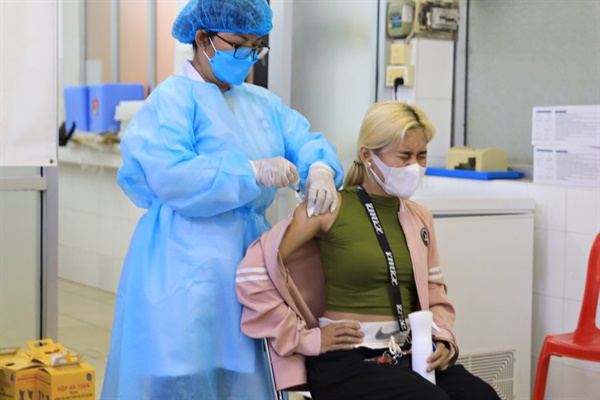 현지 종합병원에서 3차 백신을 맞고 있는 현지인 여성이 얼굴을 찡그리고 있다.