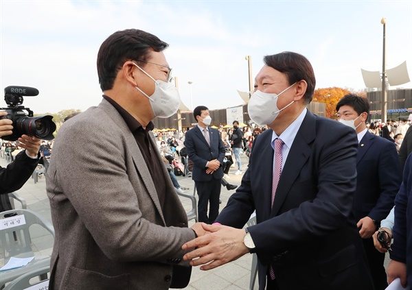  더불어민주당 송영길 대표(왼쪽)가 6일 오후 서울 송파구 올림픽공원 평화의광장에서 열린 제5회 대한민국 청년의 날 기념식에 참석, 국민의힘 윤석열 대선 후보와 인사를 나누고 있다. 