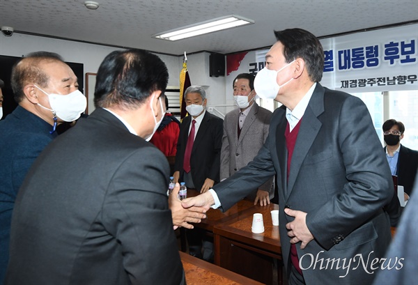  국민의힘 윤석열 대선후보가 8일 서울 서초구 재경광주전남향우회 회의실에서 열린 '윤석열 대선후보 초청 간담회'에서 참석자들과 인사하고 있다.