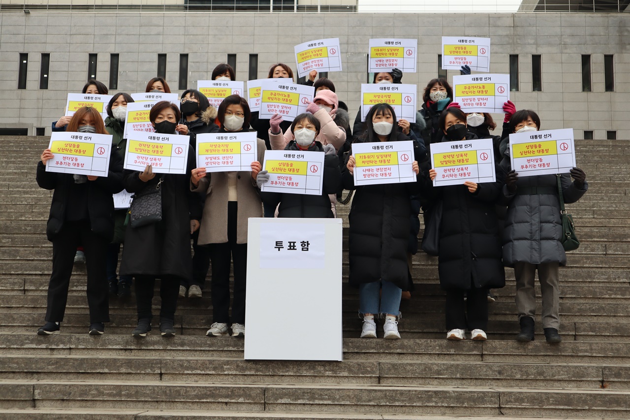 투표 퍼포먼스 여성들이 성평등을 실천하는 대통령을 원한다는 피켓을 들고 투표함 앞에 서있다.