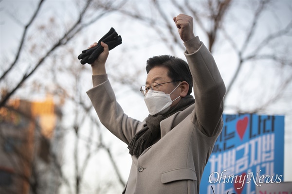 더불어민주당 이재명 대선 후보가 21일 서울 마포구 연남동 거리에서 열린 '걸어서 민심 속으로' 연남동 거리 걷기 행사에서 환호하는 시민들을 향해 양손을 들어보고 있다. 이 후보 뒤로 차별금지법 제정 촉구 피켓이 보인다. 